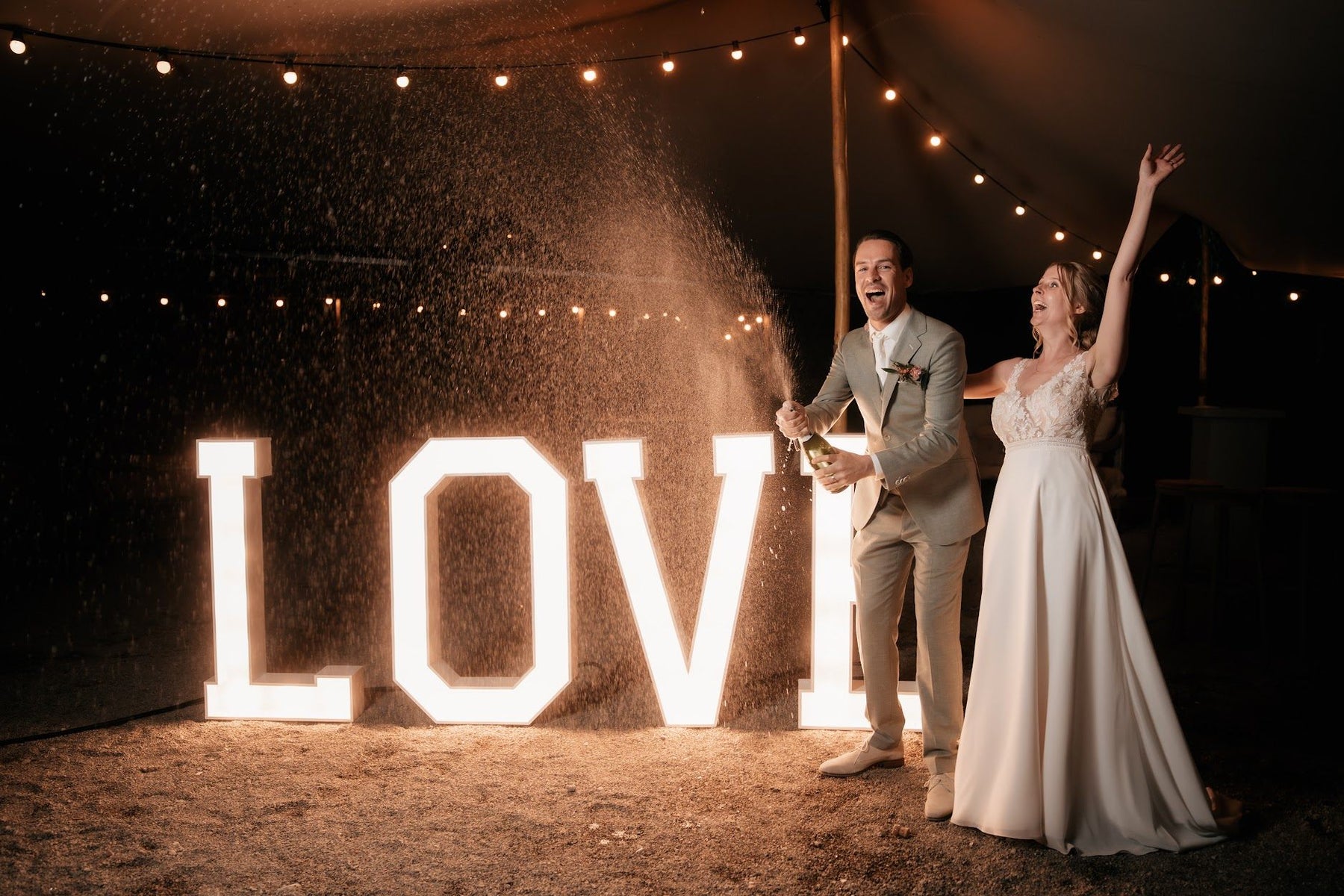 Bruidspaar bij de verlichte LOVE lichtletters